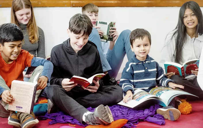 Happy children reading Scholastic books